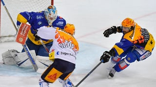 Dus giugaders da hockey davant la porta dal goli e il goli è en la porta.