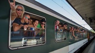Tren special cun viagiaturs giuvens che guardan ord fanestra.