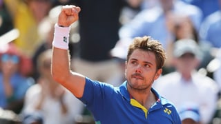 Purtret da Stan Wawrinka en posa cun il pugn en l'aria. 