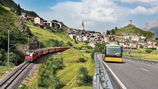 Purtret d'in tren da la Viafier retica ed ina posta, davostier è da vesair Scuol. 