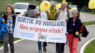 Demonstrants da diversas regiuns èn sa radunads a Windisch - duas dunnas tegnan in transparent cun si: Sortir du nucléaire - une urgence vitale!