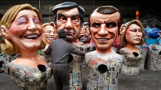 Purtret da caricaturas dals trais candidats. 