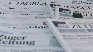 Gasettas da la gruppa da medias NZZ e la AZ Medien sin ina maisa.