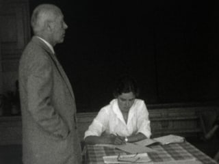 In scolast ed ina scolara durant ina lecziun il 1960. In scolast ed ina scolara durant ina lecziun il 1960.