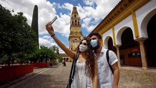 Dus turists cun protecziun da nas e bucca a Cordoba.