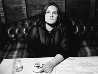 Madeleine Peyroux sesa a maisa e baiva in cafe.