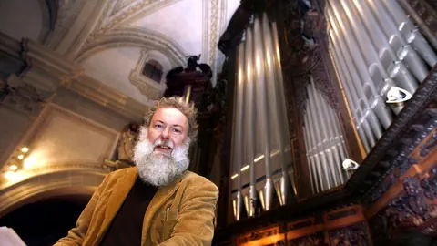 Wolfgang Sieber vor einer Kirchenorgel.