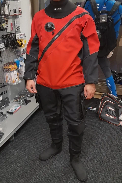 Person trägt roten Trockentauchanzug in einem Geschäft.