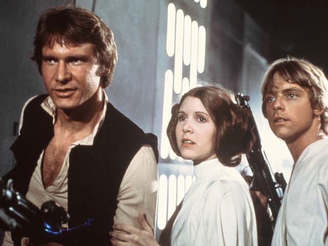 Harrison Ford sco Han Solo, Carrie Fisher sco princessa Leia e Marc Hamill sco Luke Skywalker.