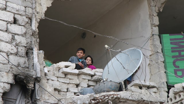 Uffants en las ruinas d'Aleppo. 