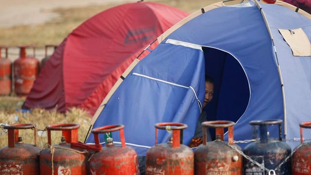 Tendas per abitar a Kathmandu. Davantvi buttiglias da gas per cuschinar vidas.