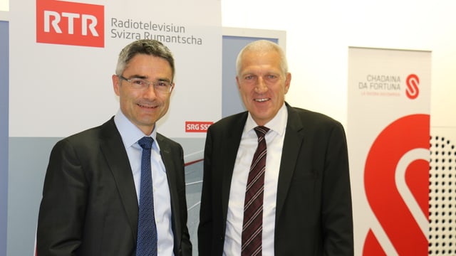 Purtret da Mario Cavigelli (Cusseglier guvernativ) e Pierin Vinzens (CEO Banca Raiffeisen). 