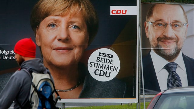 Purtret da placats da votaziun da Merkel e Schulz. 