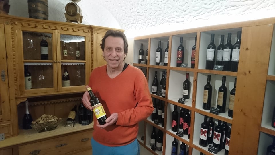 Mario Albin presenta ina buttiglia vin da messa.