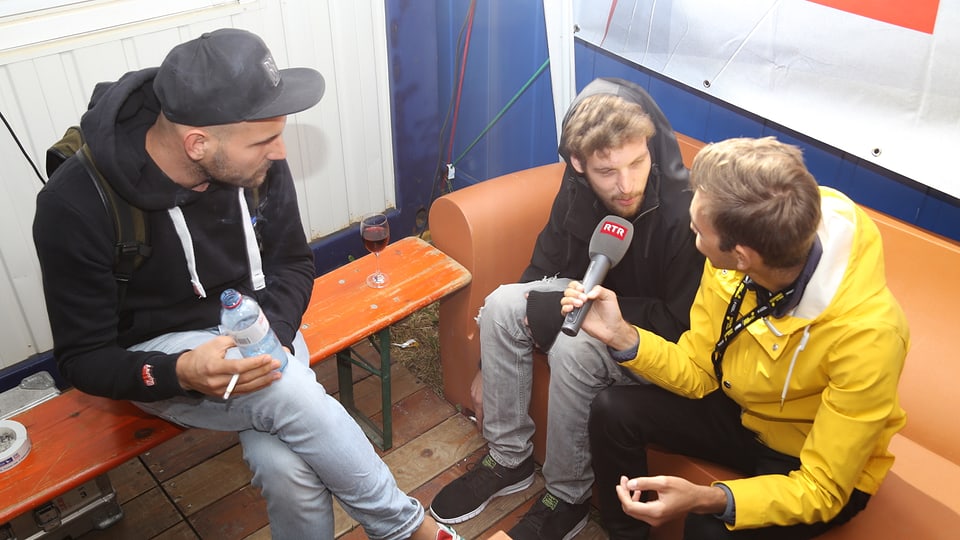 Livio Chistell (dre.) intervistescha Tobias Rieser (san.) e Adrian Held (amez), ils dus DJs da Klangkarussell Live.