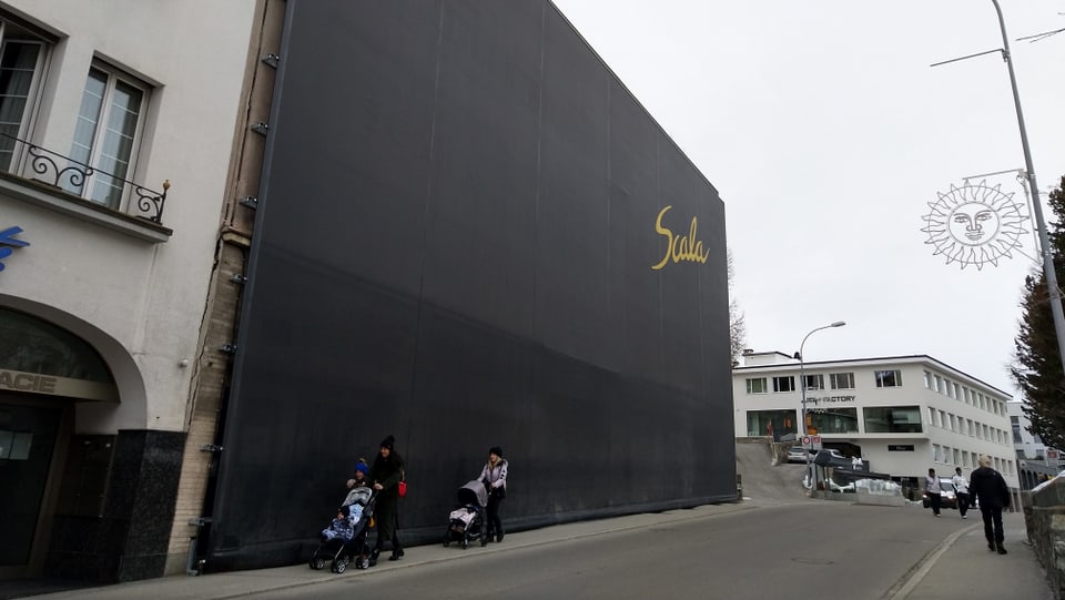 Edifizi da l'anteriur kino Scala - zuglià cun ina grondischma taila naira cun l'inscripziun "Scala".