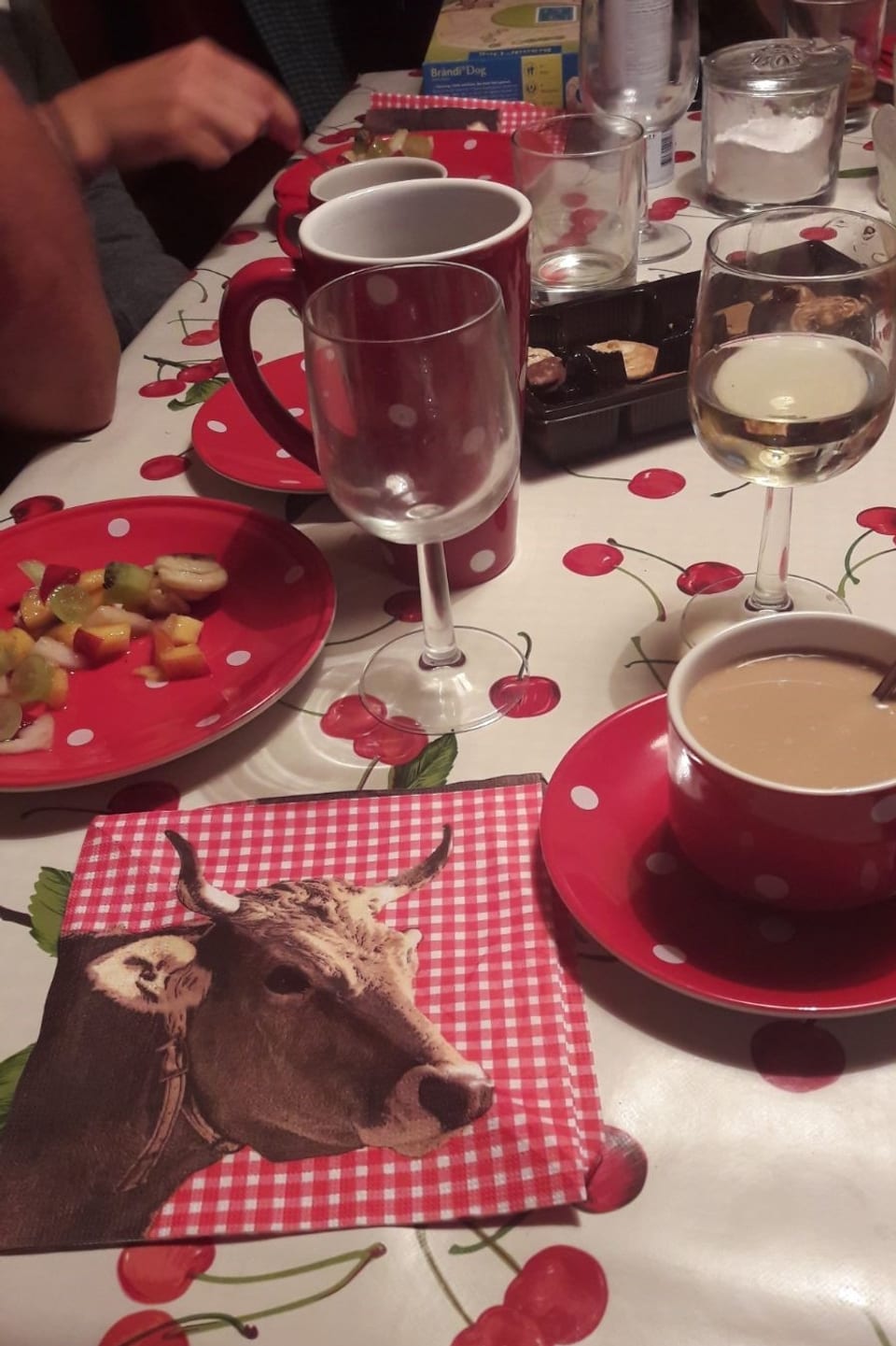 Ina maisa cun decoraziun e si scadiolas da cafe, glasa da vin e desserts.