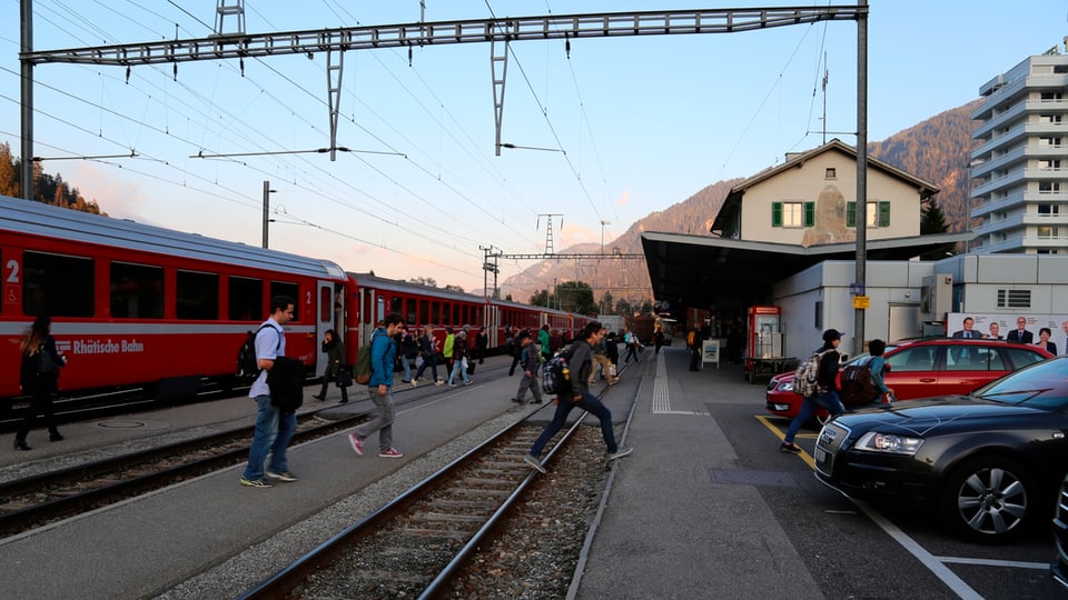 Ina staziun cun in tren e passagiers che sortan dal tren. 