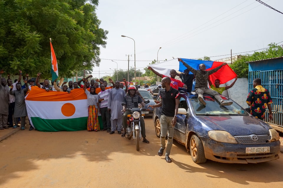 Demonstranten mit Fahnen von Russland und Niger.