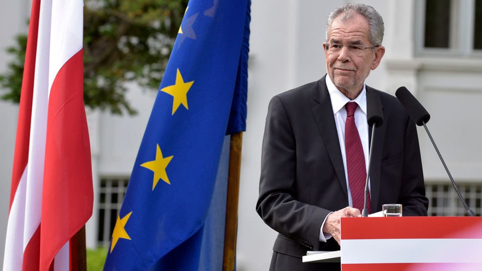 Van der bellen en ses discurs cun bandiera austriaca ed europeica.