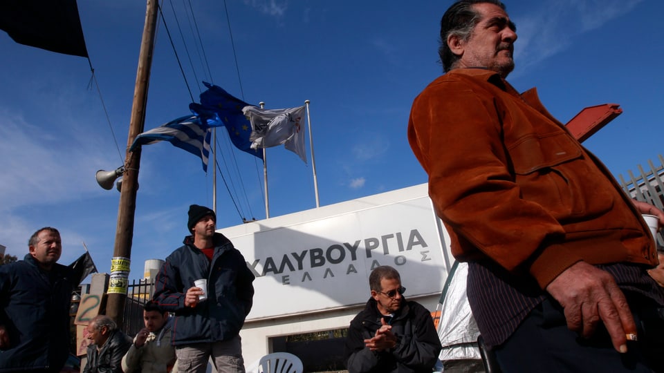 Lavurers industrials spetgan davant ina fabrica.