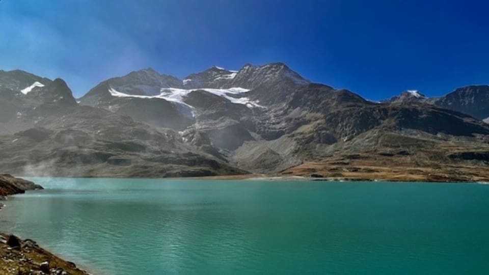 Ein See mit im Hintergrund sich auftürmenden Bergen