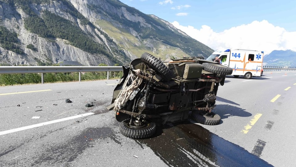 purtret da l'auto che giascha sin la vart. Davos quel vesan ins l'ambulanza cun si il numer 144. 