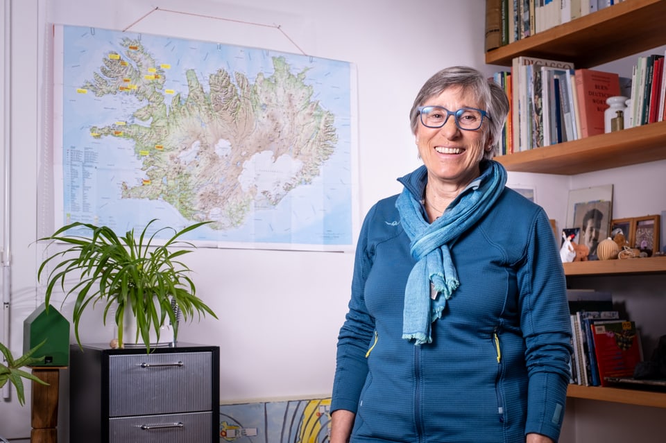 Marlena Furger Sali in ihrem Wohnzimmer vor der Karte von Island.