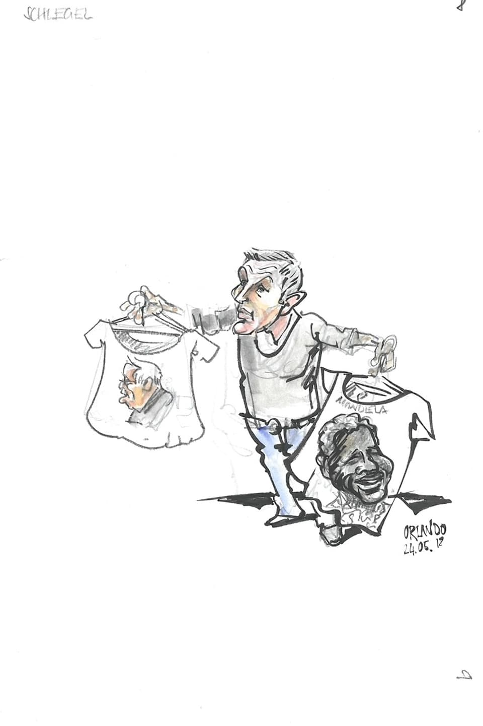 Caricatura da Schlegel che tegna dus t-shirts enta maun in cun si Nelsen Mandela, in cun si Christoph Blocher. 