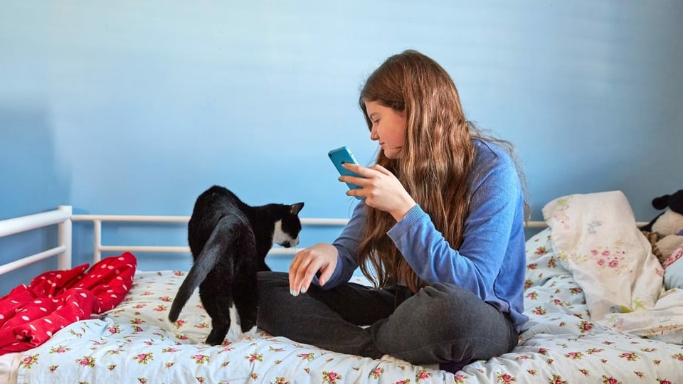 Giuvna suletta cun il telefonin.
