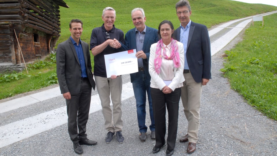 Pascal Randegger da l'assicuranza Mobiliar surdat il schec ad Aurelio Casanova, president communal da Glion.