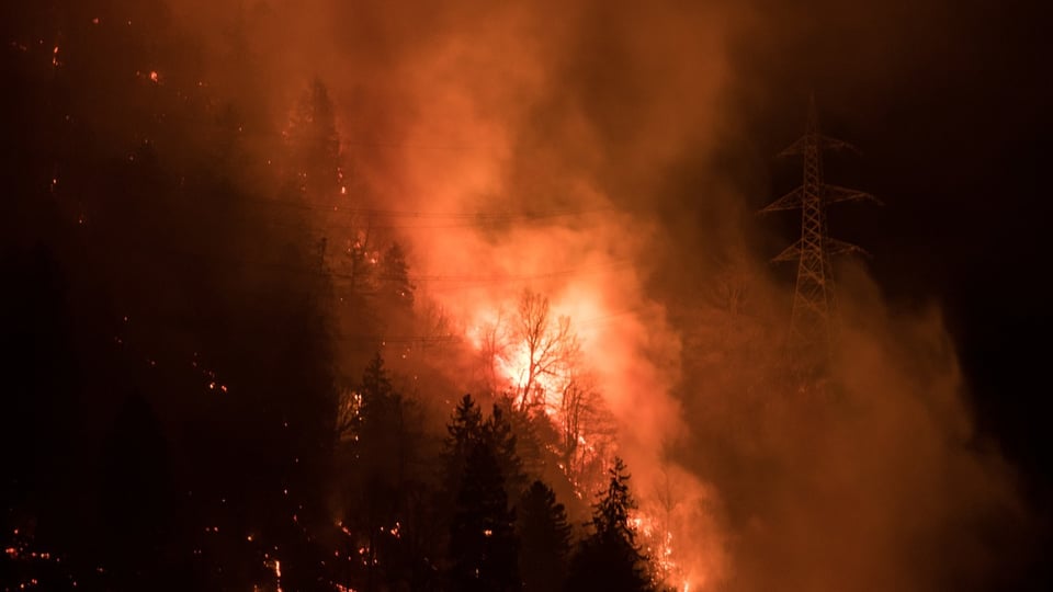 A forest fire burns in the Misox valley between Mesocco and Soazza, in the canton of Grisons, Switzerland.